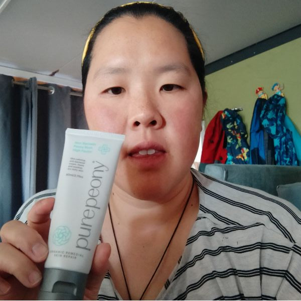 customer holding sugarcane tube of high factor partially obscuring her face