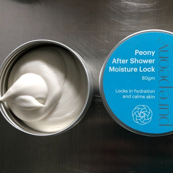 Open 80gm tin of Peony After Shower Moisture Lock next to closed tin showing label