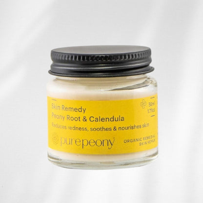 Jar of Skin Remedy with Peony Root & Calendula on a white background