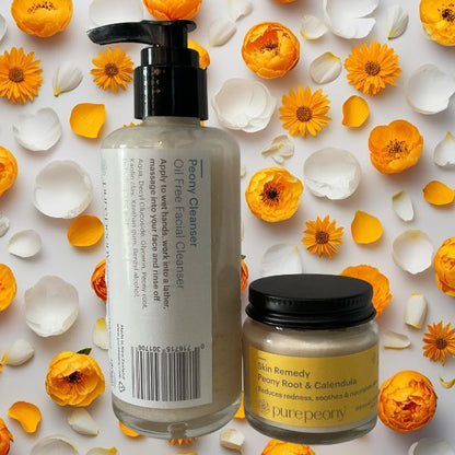 white peony petals and yellow calendula behind the peony cleanser and peony and calendula skin remedy rosacea relief duo skincare