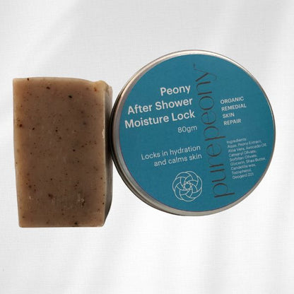Unboxed bar of Healing Body Bar, eczema soap alongside 80gm tin of Peony After Shower Moisture Lock for Dry Skin Relief