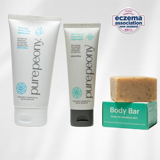 Eczema approved purepeony skincare moisturiser and treatment cream and a body bar with a box on a white background.