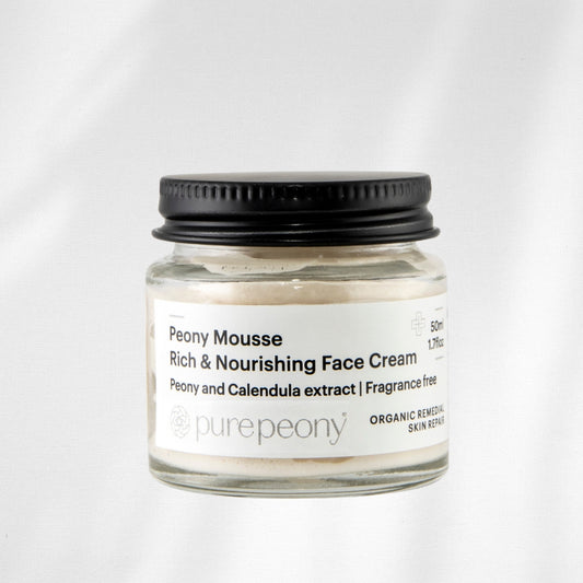 Jar of Peony Mousse Rich & Nourishing Face Cream with a black lid on a white background
