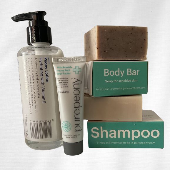 Winter calm and restore pack for ezema skin with Peony Lotion in glass bottle and 20ml sugarcane tube of best eczema cream and body bar and shampoo bars on display out of their boxes