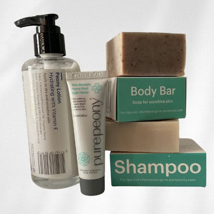 Winter calm and restore pack for ezema skin with Peony Lotion in glass bottle and 20ml sugarcane tube of best eczema cream and body bar and shampoo bars on display out of their boxes