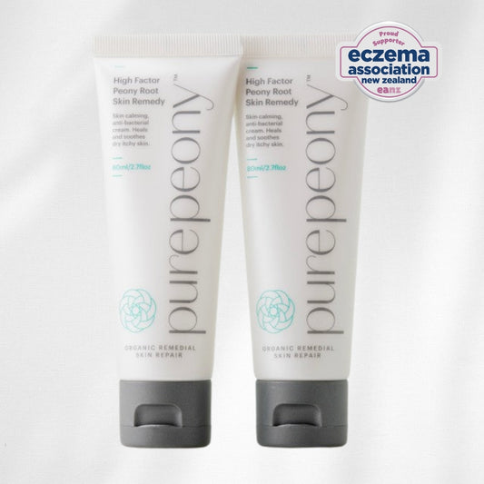 Two sugarcane tubes of purepeony skin remedy on a white background with Eczema Association New Zealand logo.